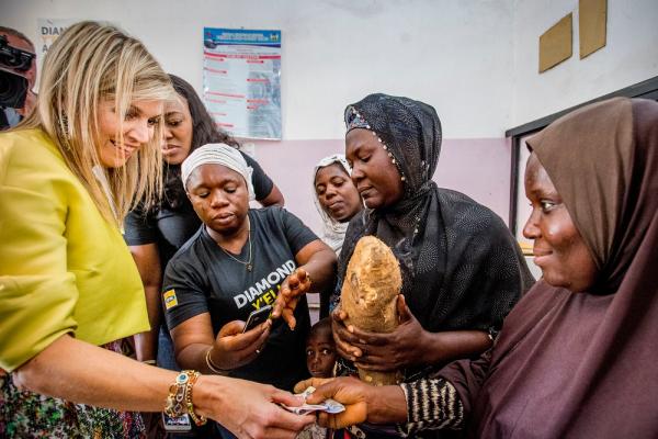 In Nigeria, Queen Máxima met with women who understand in personal terms the supply and demand sides of mobile money: a Diamond Yello agent and her client.  Photo credit: UNSGSA/Robin Utrecht